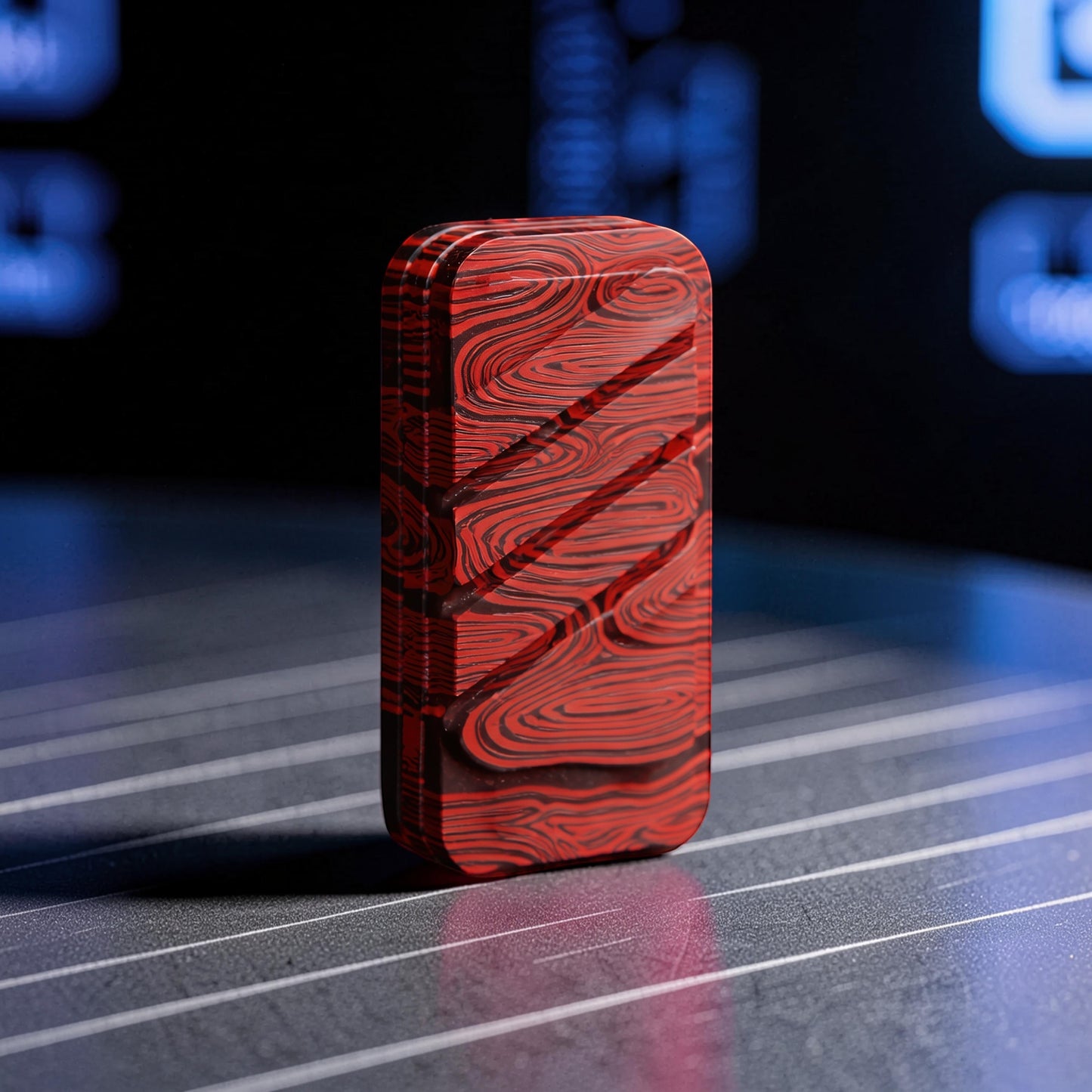 The Curious Mind Three-Layer Push Card Slider fidget toy in red and black Damascus pattern, compact fiberglass construction.