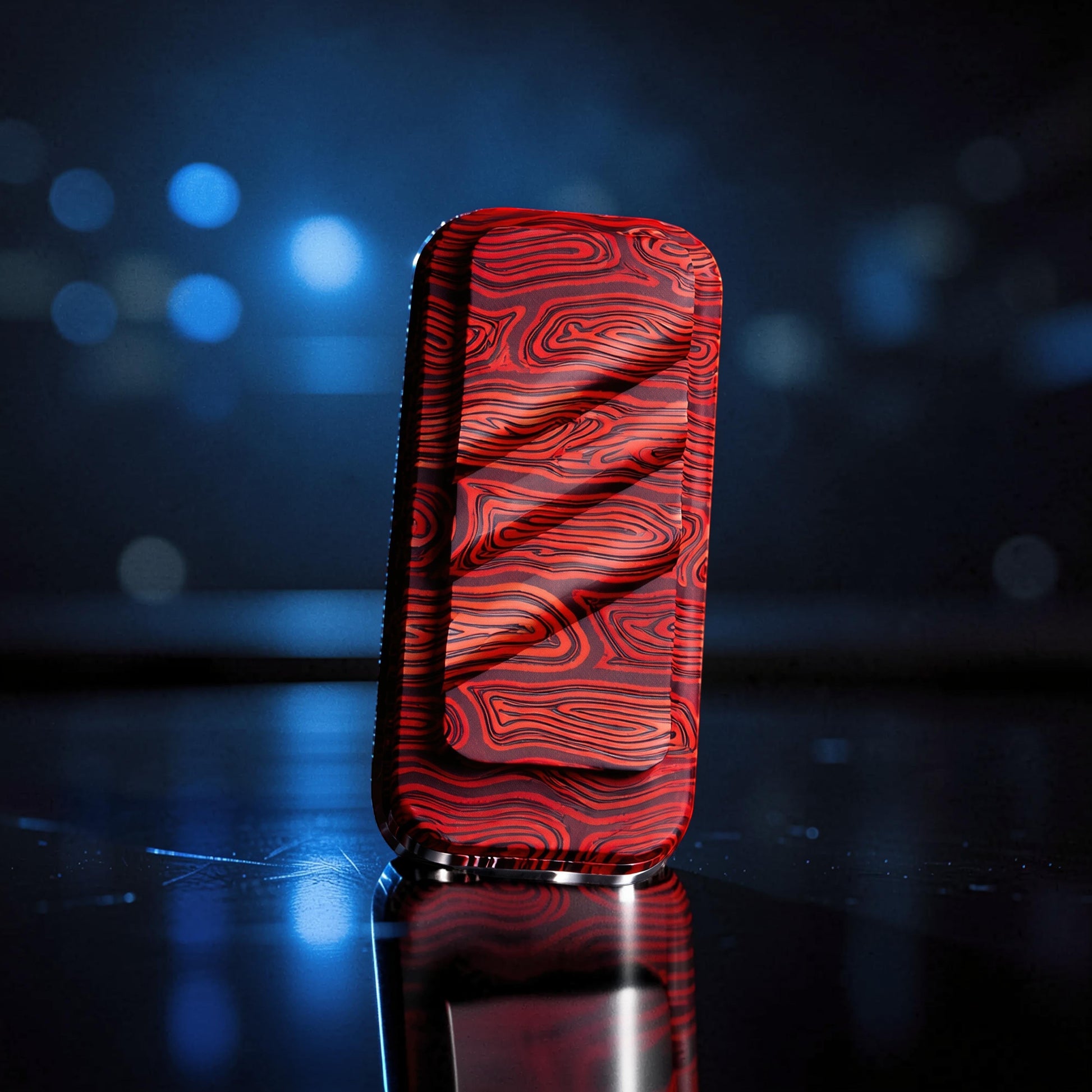 The Curious Mind Three-Layer Push Card Slider fidget toy with a red and black wood grain pattern. Compact metal design.