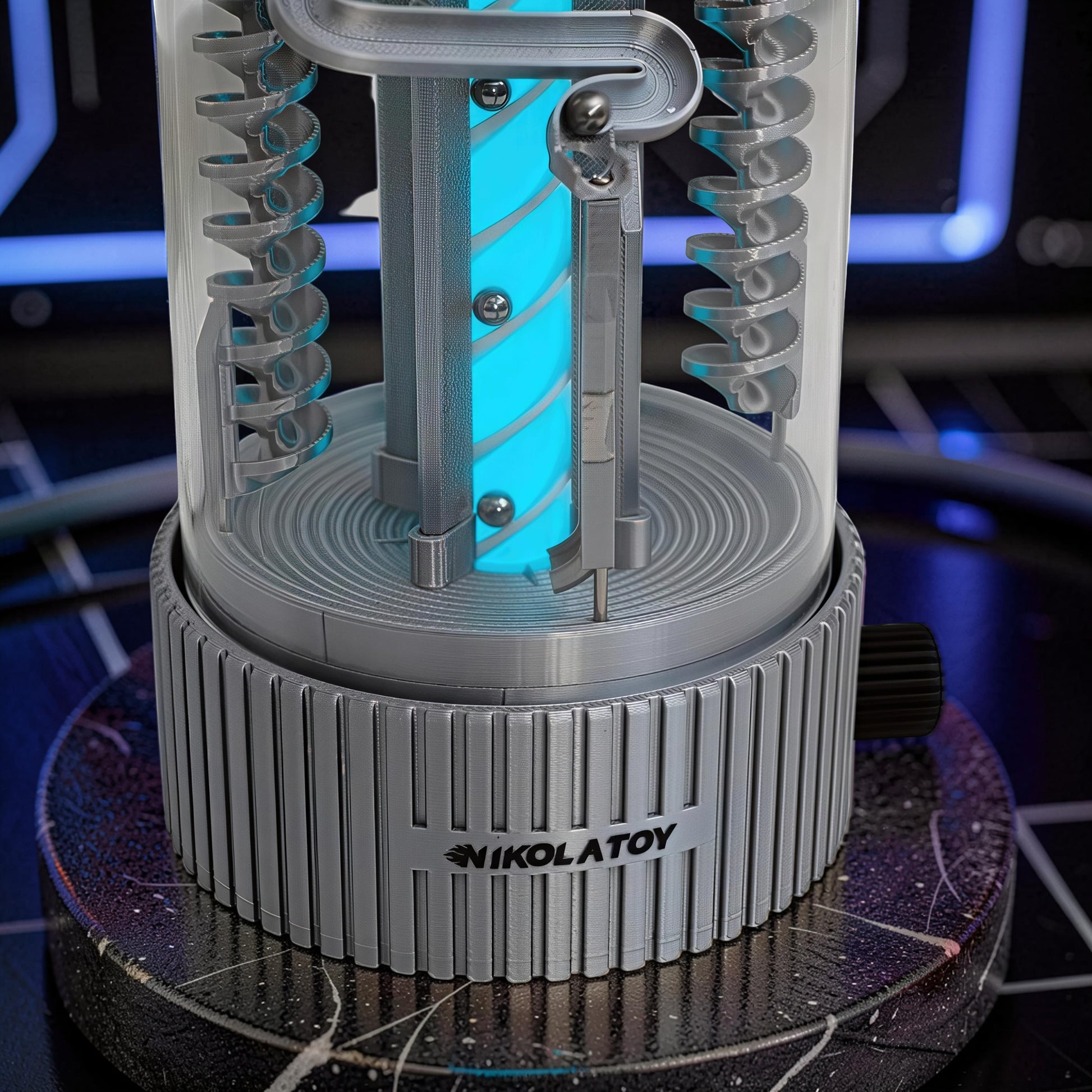 The Curious Mind Spinning Pinball RGB Night Light features a clear cylinder with a blue glowing core and silver spiral tracks. PLA material.