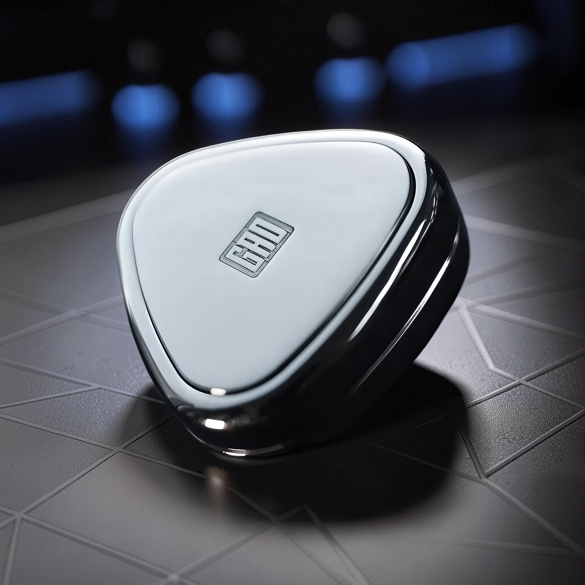 The Curious Mind Rice Ball Push Card Fidget, a compact, metallic slider with a sleek, polished finish and engraved logo.