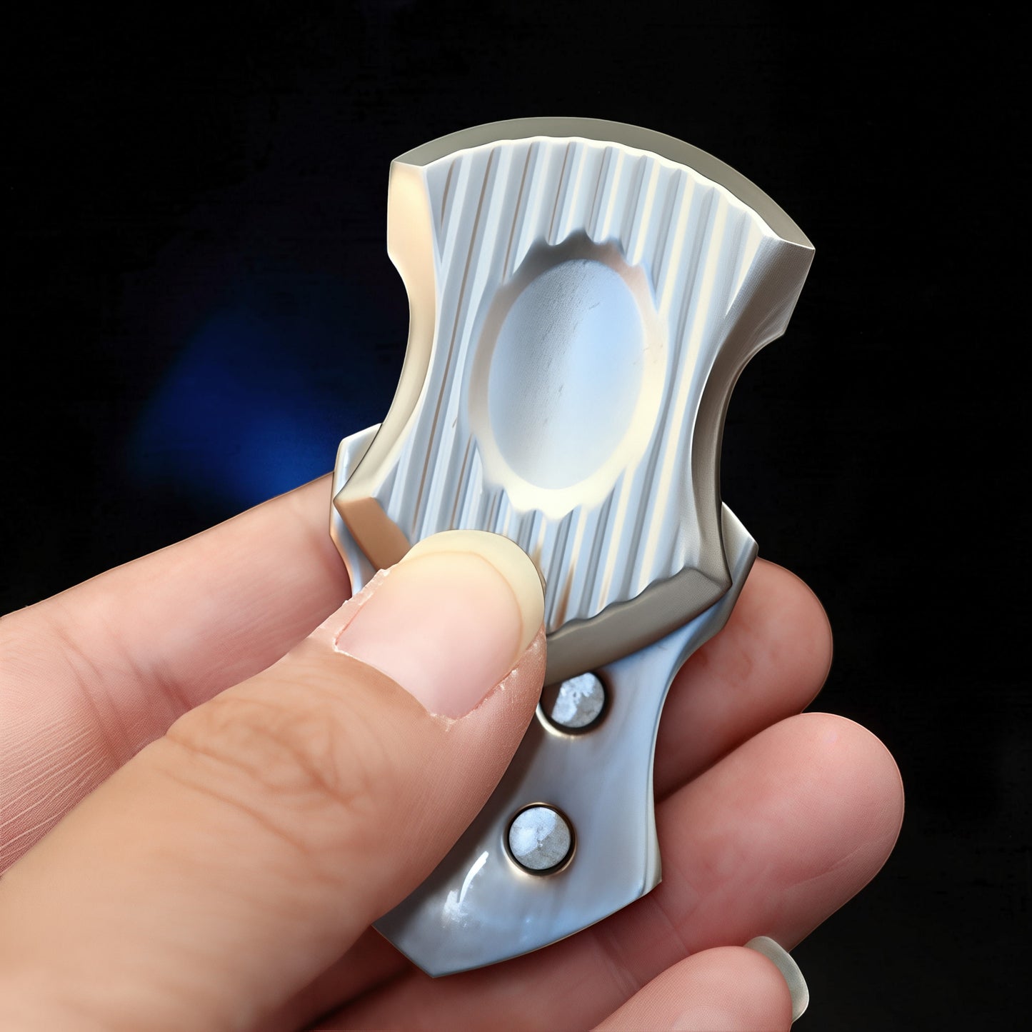 The Curious Mind Shield Fingertip Spinner, a compact EDC metal fidget toy with a ribbed silver finish and two visible rivets.