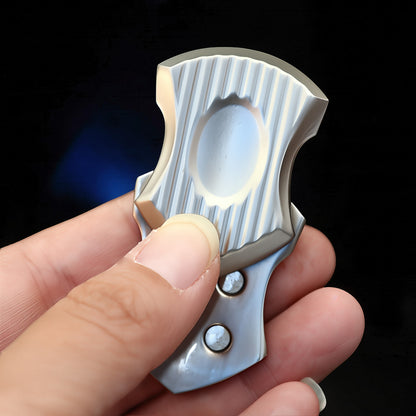 The Curious Mind Shield Fingertip Spinner, a compact EDC metal fidget toy with a ribbed silver finish and two visible rivets.