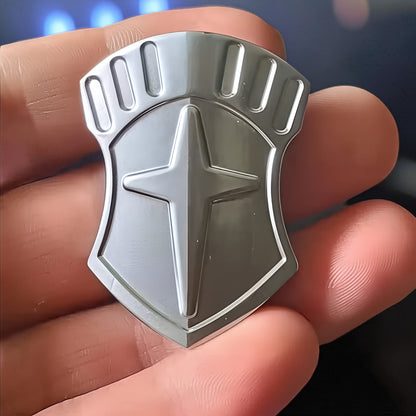 The Curious Mind Shield Fingertip Spinner, a compact EDC metal spinner with a shield design and star emblem, held in a hand.