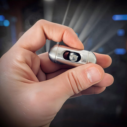 The Curious Mind silver metal egg pocket spinner with a central bearing, held in a hand.