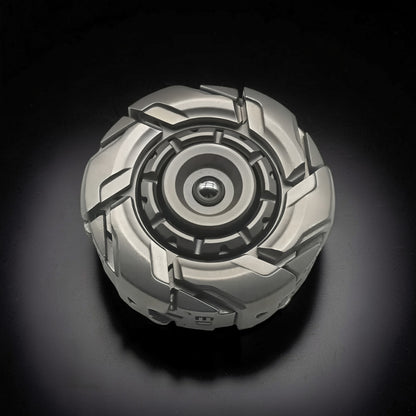 The Curious Mind Open Armour magnetic spinner in silver metal with a complex, segmented design and central bearing.