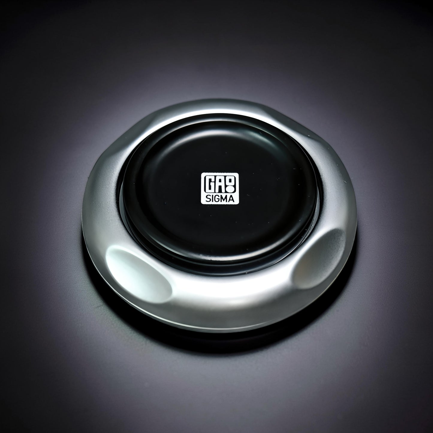 The Curious Mind Magnetic Master 2.0 spinner in silver metal with a black center featuring the GAS SIGMA logo.