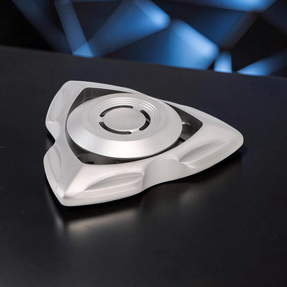 The Curious Mind silver stainless steel tri-blade spinner with a sleek, aerodynamic design. Perfect for EDC, desk toy, or gift.