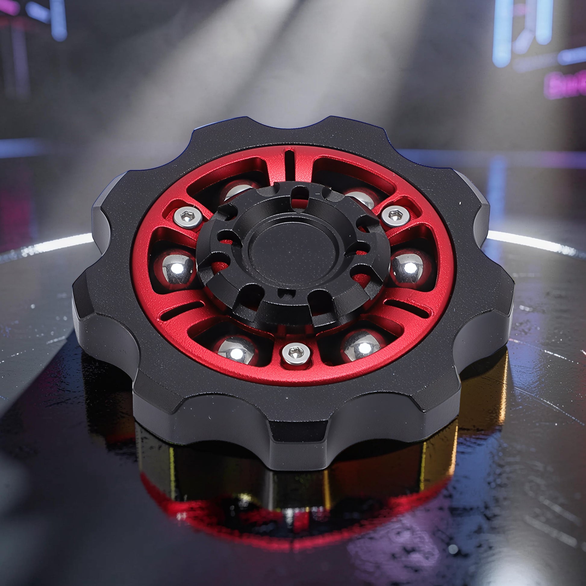 The Curious Mind Six-Bead Gear Spinner: black metal with red gear-style frame, six silver ball bearings, and central black hub.
