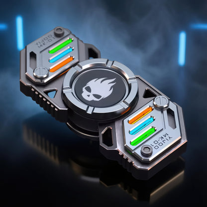 The Curious Mind Skull Wheel 2-Blade Spinner Gift Set features a metal spinner with a skull emblem and glow accents in green, blue, and orange.