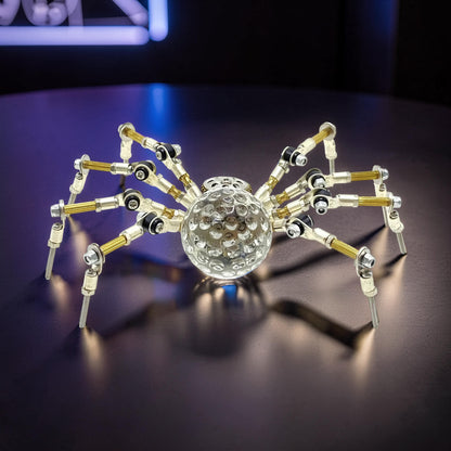 The Curious Mind Spider DIY Kit Style G, a mechanical steampunk spider model with a clear crystal body and metal legs.
