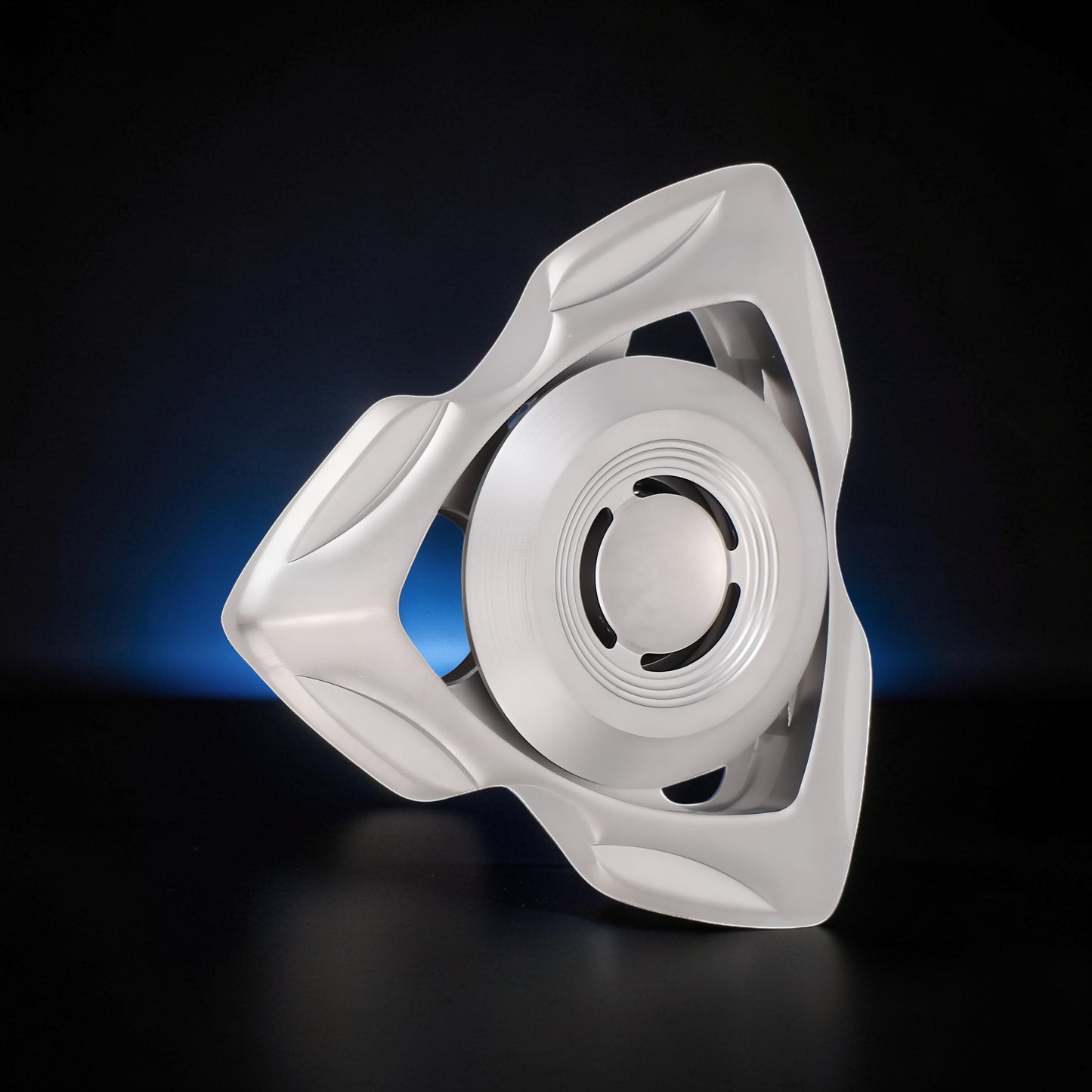 The Curious Mind premium stainless steel tri-blade spinner with a unique, sculpted frame and a central rotating disc.