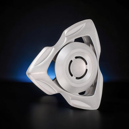 The Curious Mind premium stainless steel tri-blade spinner with a unique, sculpted frame and a central rotating disc.