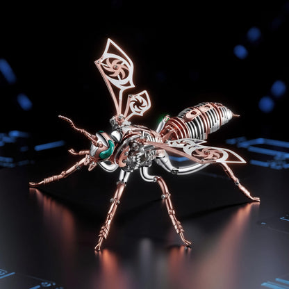 The Curious Mind Stainless Wasp 3D metal model kit with silver, gold, and copper tones. Intricate mechanical design with detailed wings and body.