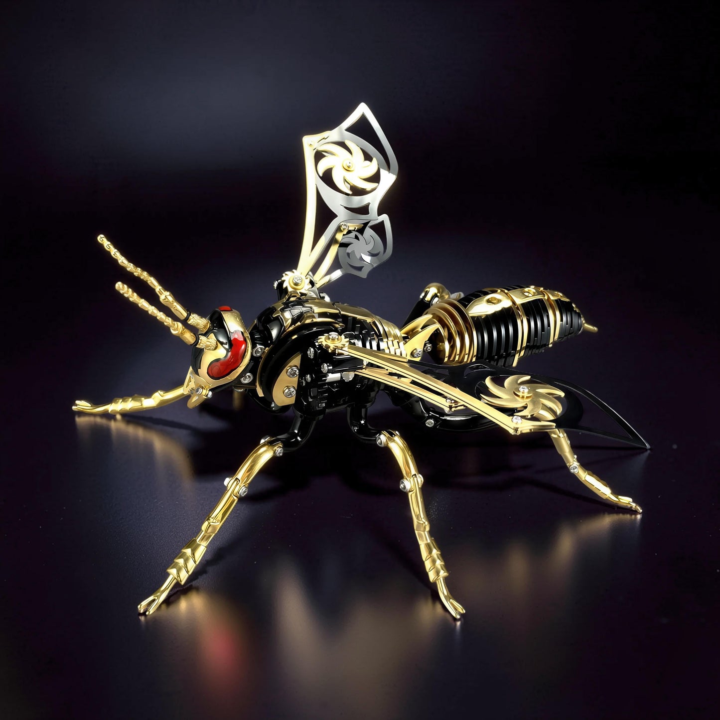 The Curious Mind Stainless Wasp 3D metal model kit, black and gold with red eyes, intricate mechanical design.