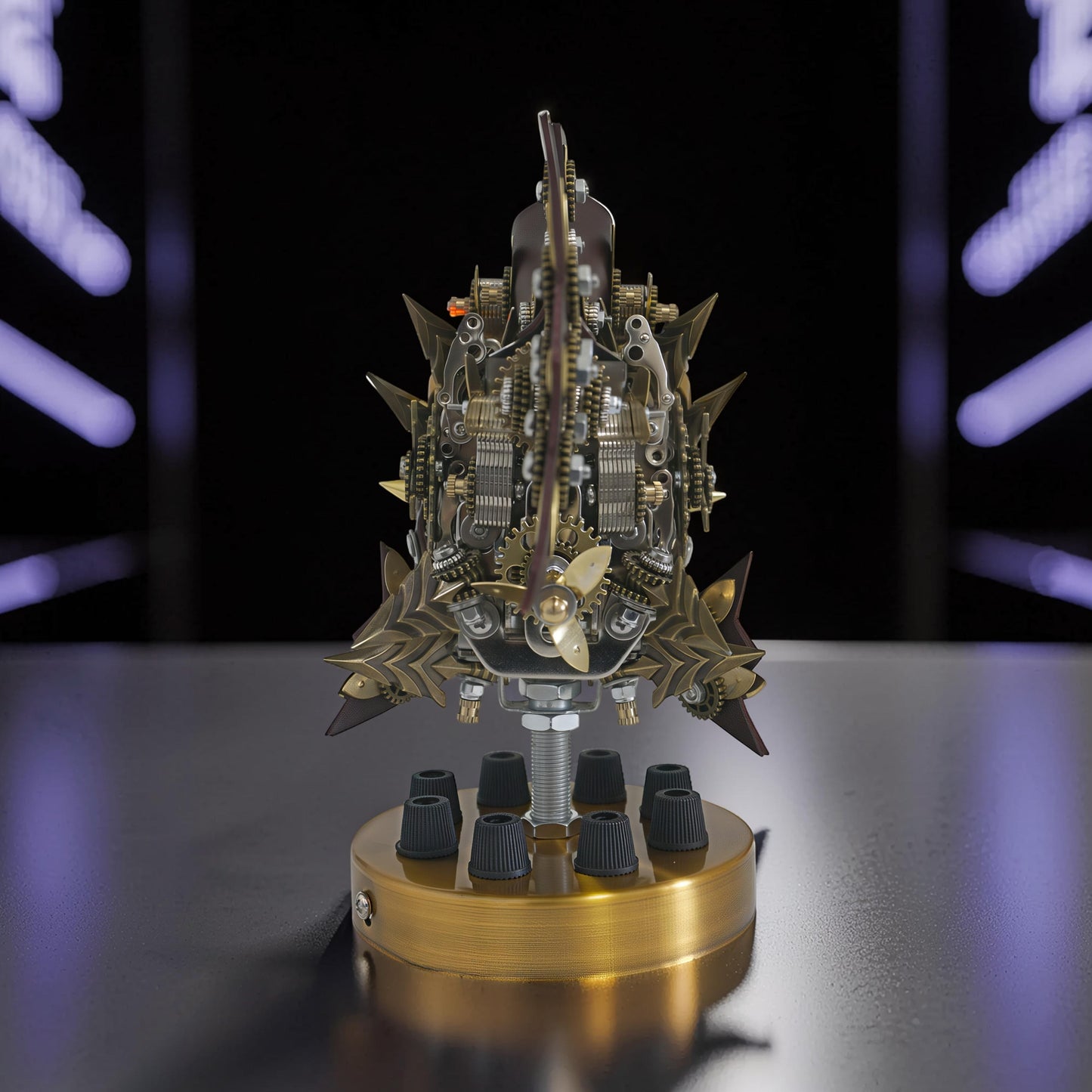 The Curious Mind Steampunk Anglerfish metal model kit with intricate gears and a brass propeller, displayed on a gold base with black knobs.