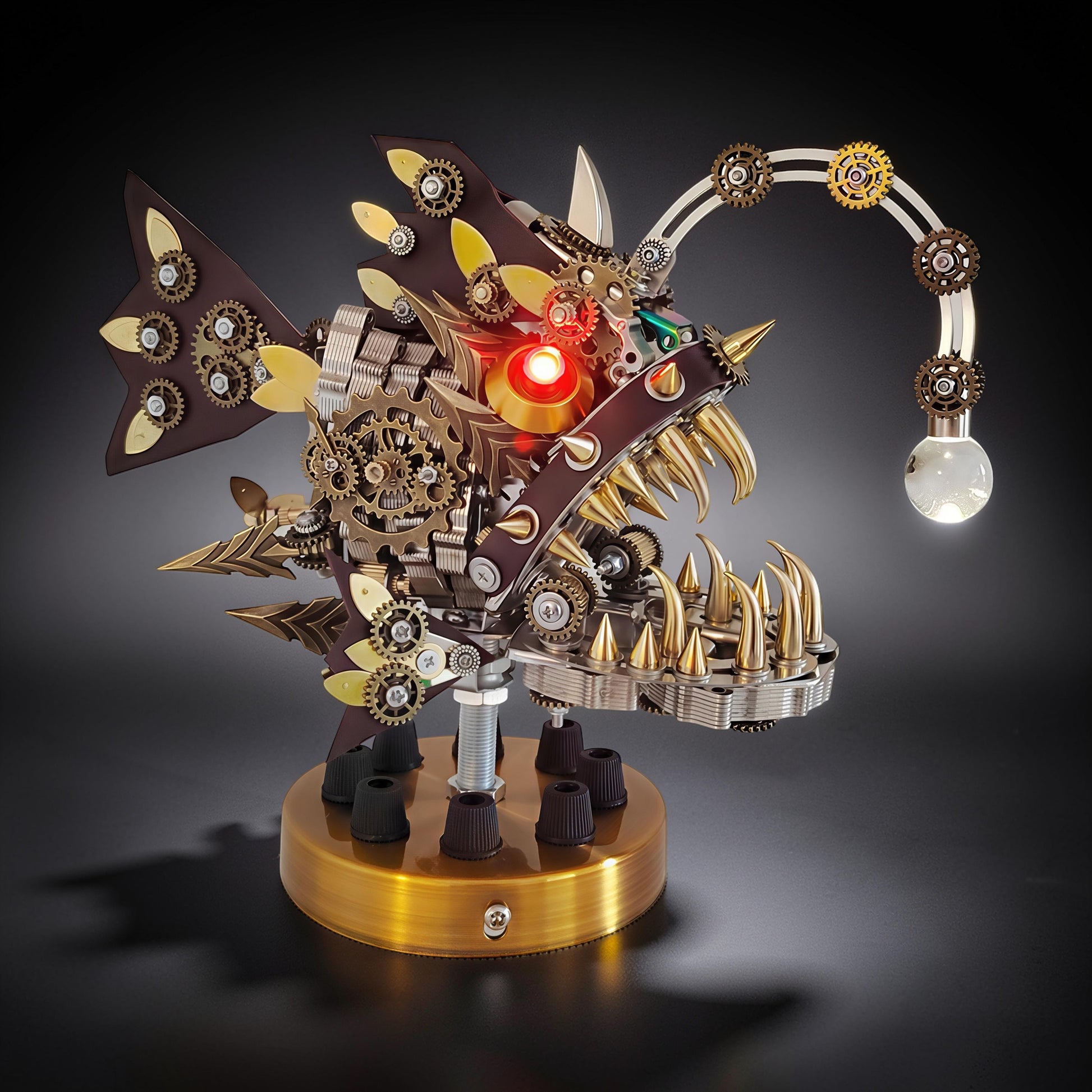 The Curious Mind Steampunk Anglerfish metal model kit with display base, featuring intricate gears, sharp teeth, and a light-up lure.