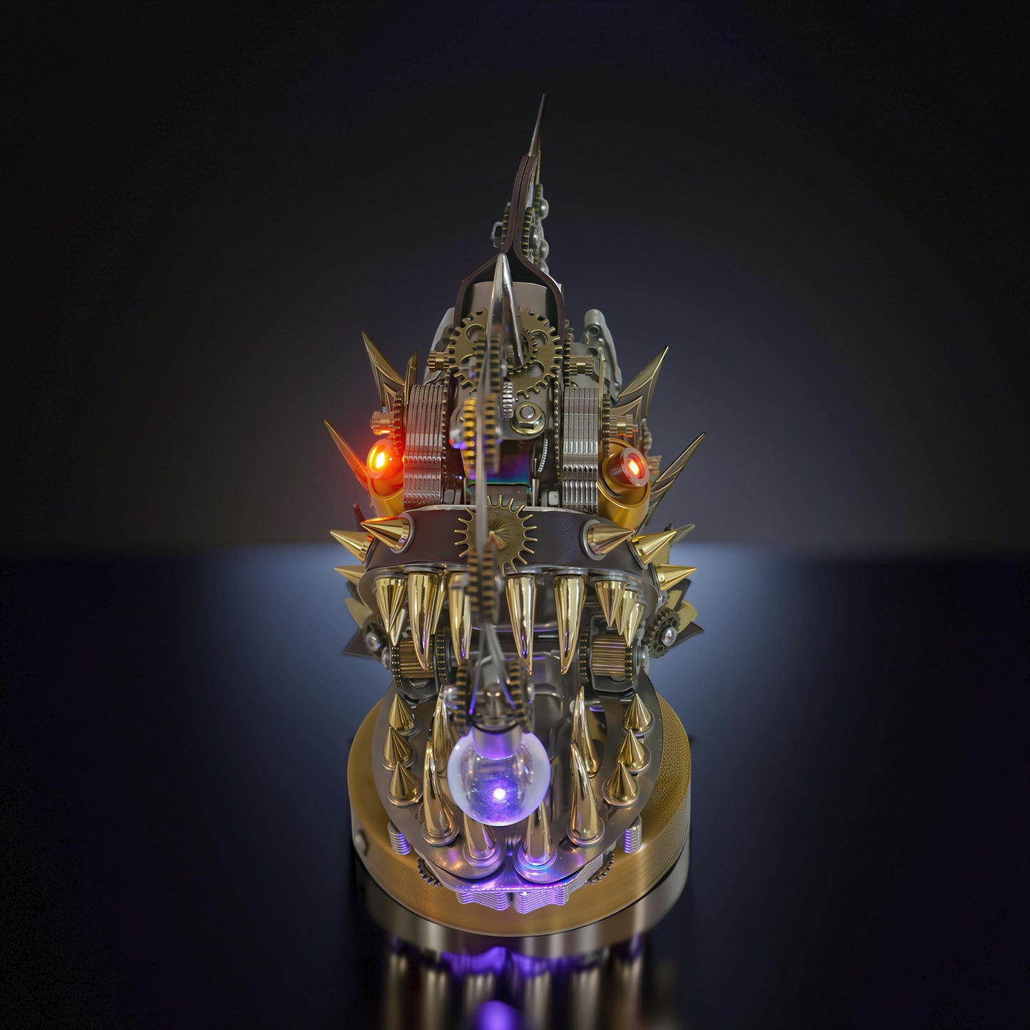 The Curious Mind Steampunk Anglerfish metal model kit with illuminated eyes and a glowing orb, featuring intricate gears and sharp teeth on a display base.