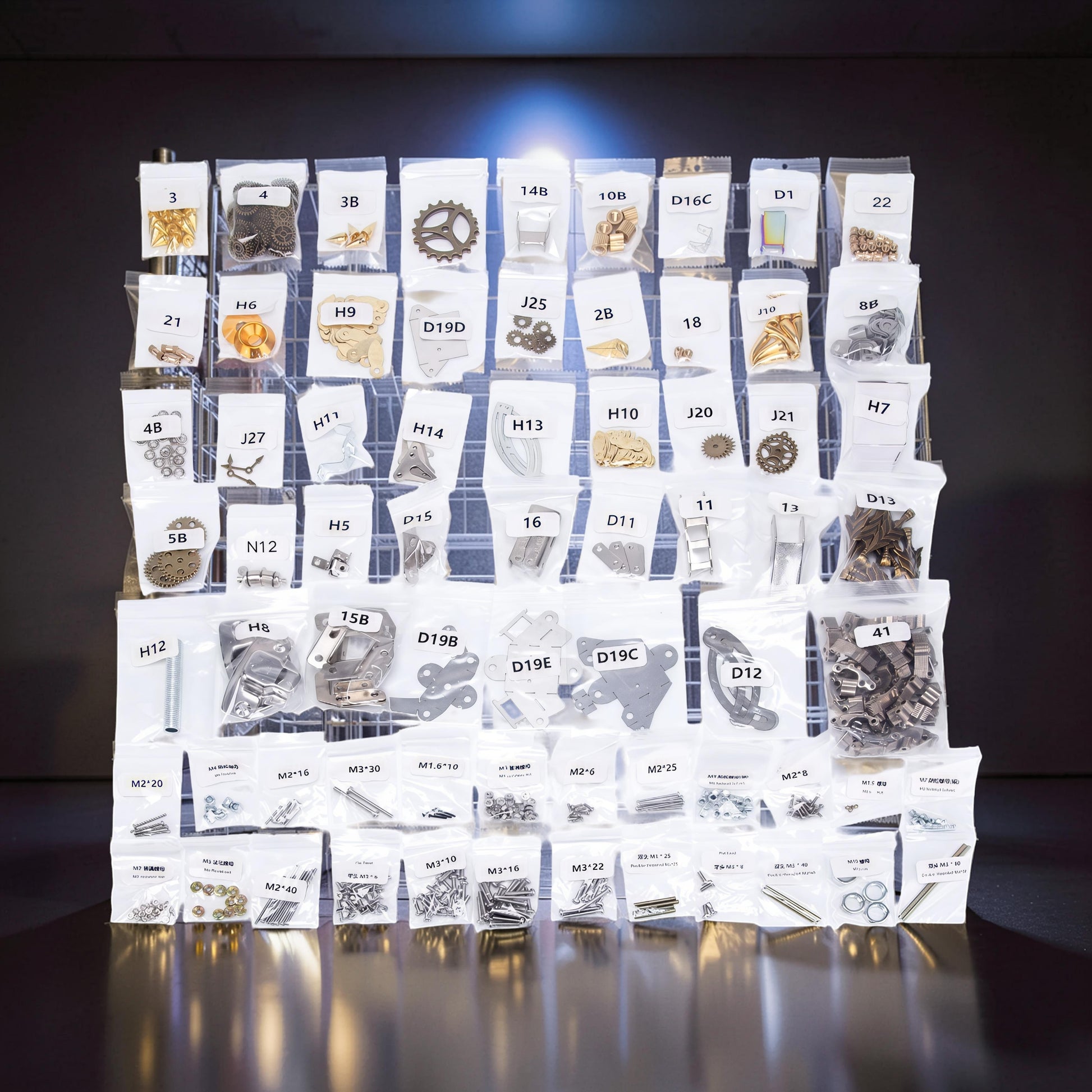 The Curious Mind Steampunk Anglerfish metal model kit parts laid out in labeled bags on a grid.