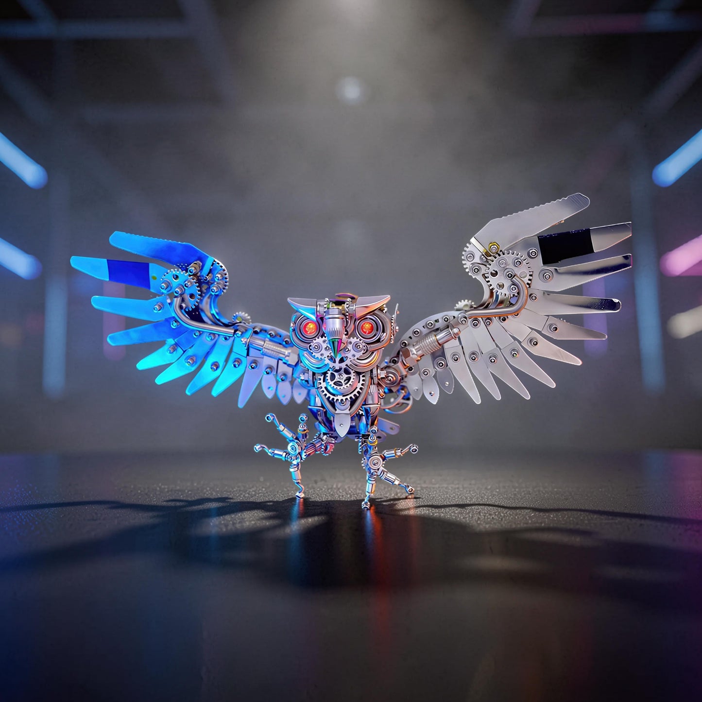 The Curious Mind Steampunk Owl 3D metal model kit with intricate gears, metallic silver and blue wings, and red glowing eyes.