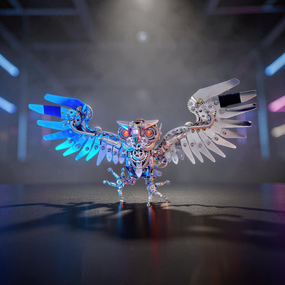 The Curious Mind Steampunk Owl 3D metal model kit with intricate gears, metallic silver and blue wings, and red glowing eyes.
