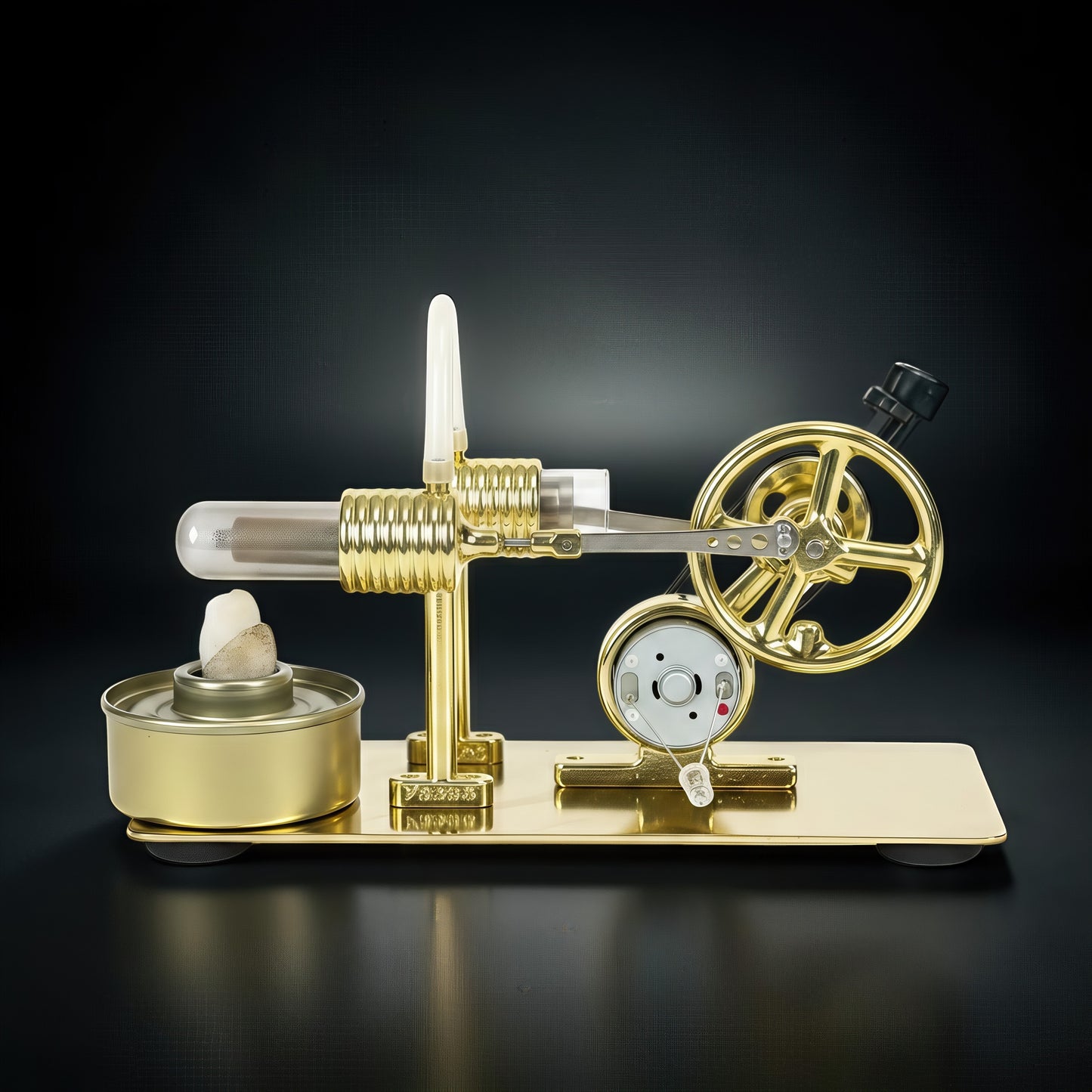 The Curious Mind Classic Stirling Engine DIY Kit, a polished gold metal model with a glass cylinder and flywheel, on a black background.