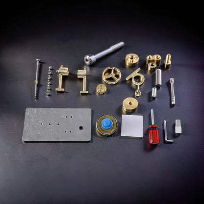 The Curious Mind Classic Stirling Engine DIY Kit with metal parts laid out, including a flywheel, cylinders, screws, and tools.