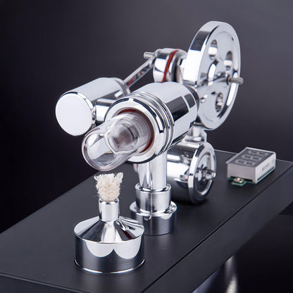 The Curious Mind mirror-polished metal Stirling engine model with voltmeter and USB port, featuring a glass cylinder and a fuel burner.