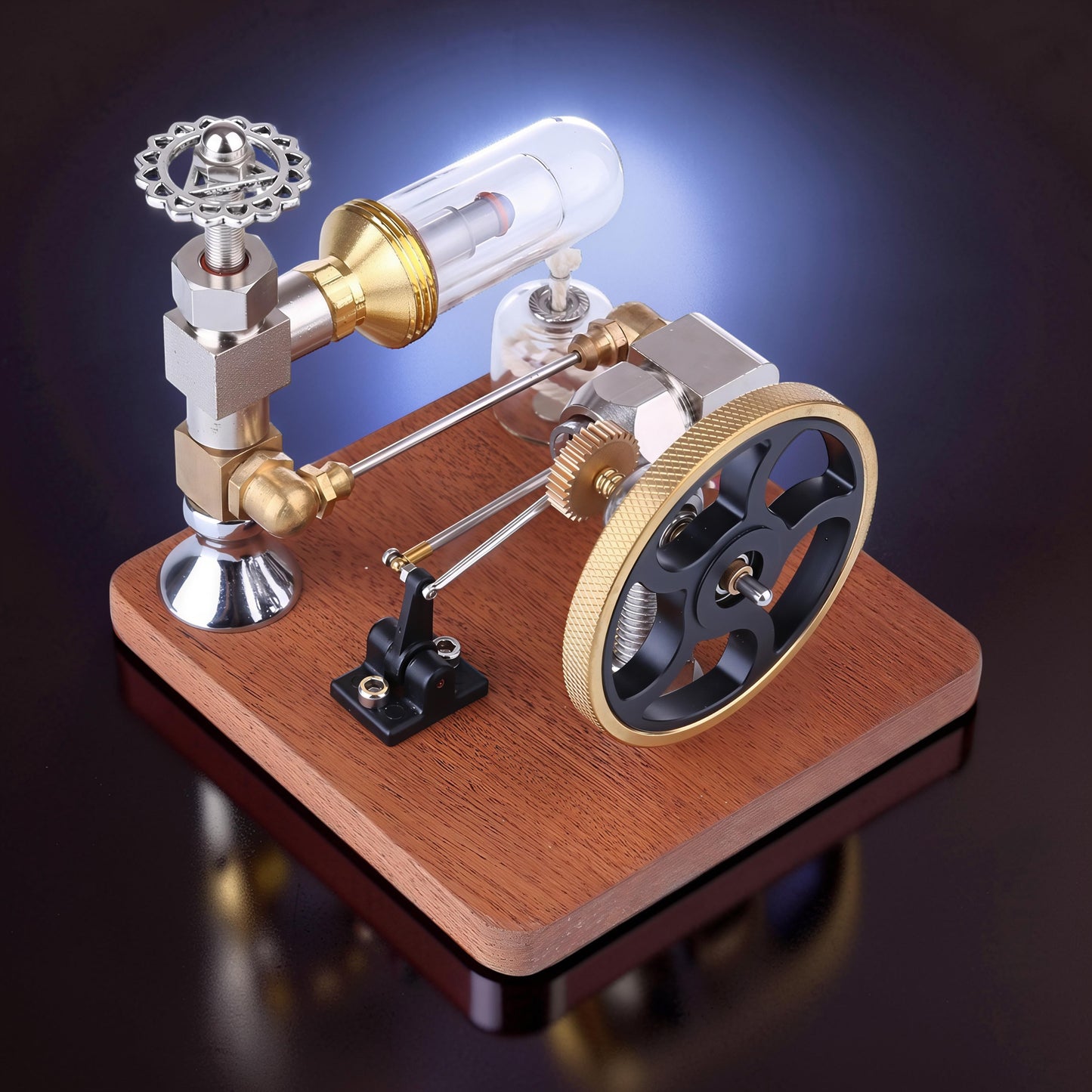 The Curious Mind Stirling Engine model with metal, wood, and quartz glass construction, featuring a flywheel and adjustable speed controller.