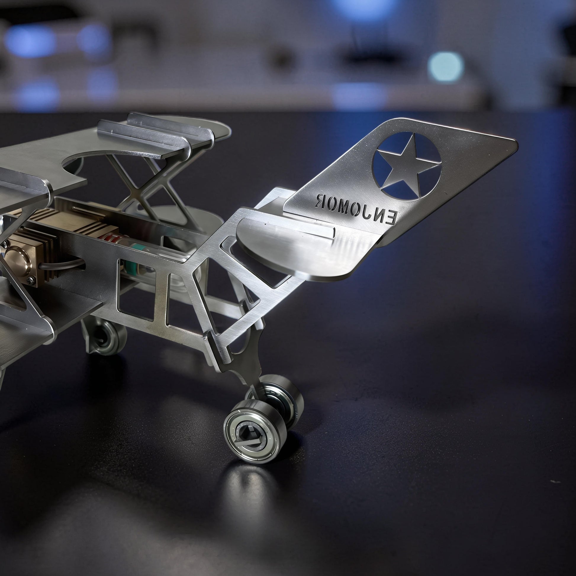 The Curious Mind Stirling Engine Model Aircraft, a metal desktop display model with mechanical movement and a star emblem on the tail.