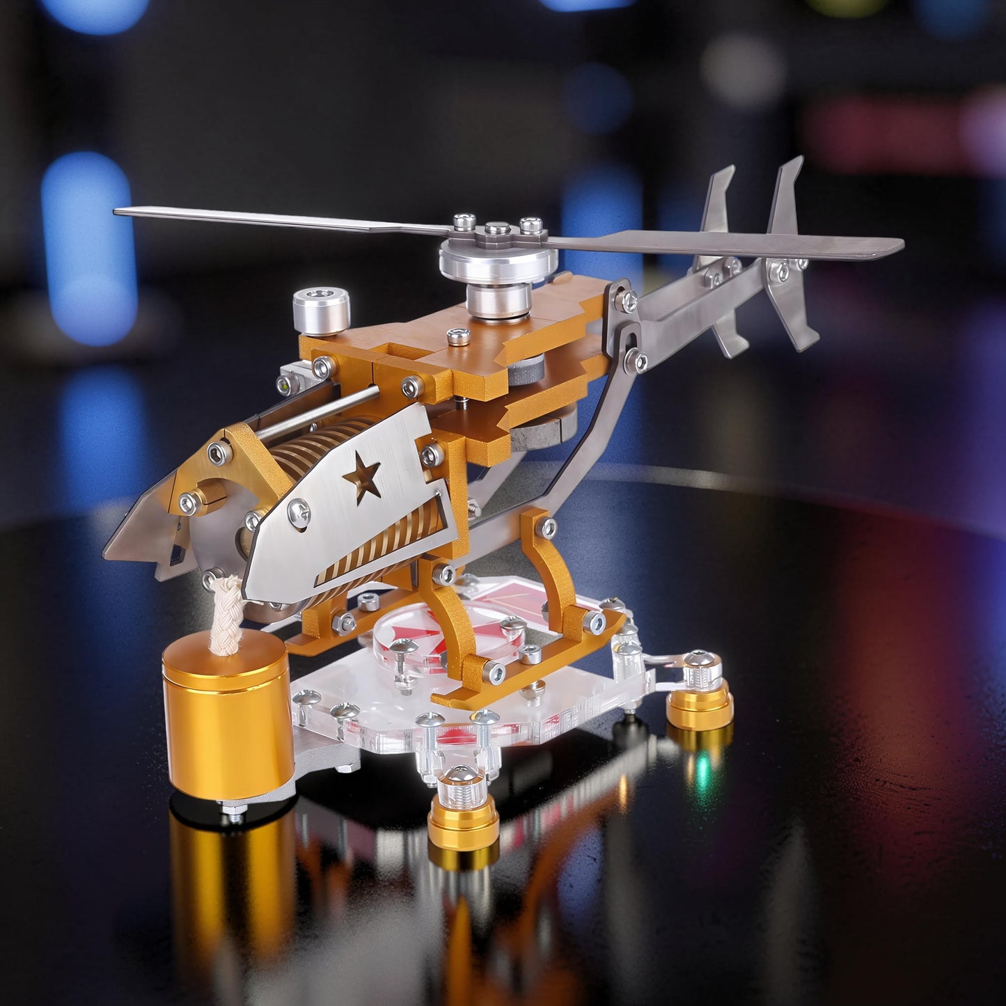 The Curious Mind Fire-Absorbing Stirling Helicopter Model, a detailed metal engine display with gold and silver accents, featuring a star emblem and spinning rotor.