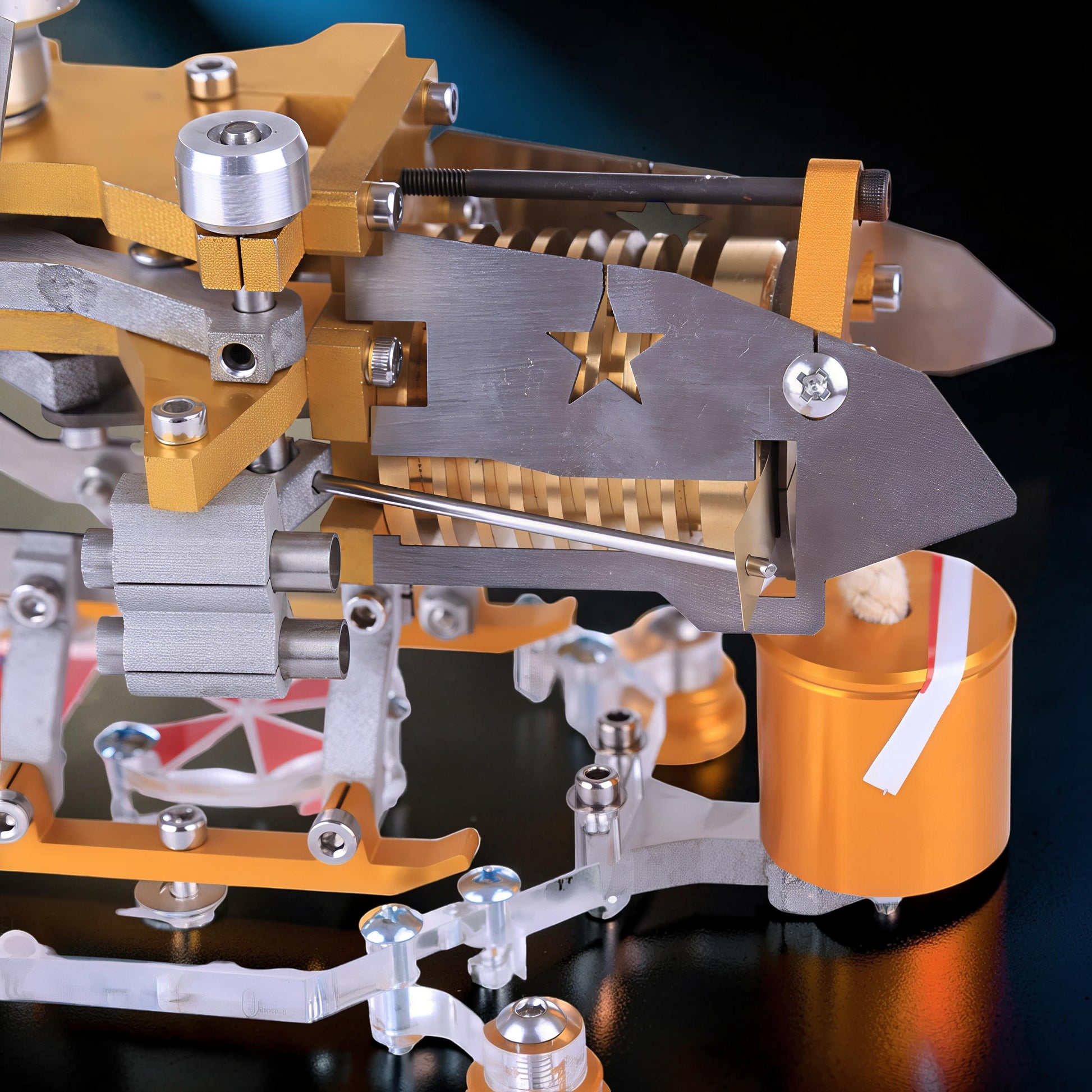 The Curious Mind Fire-Absorbing Stirling Helicopter Model, a detailed metal engine display with gold and silver accents, featuring a star cutout.