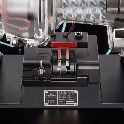 The Curious Mind T700 Turboshaft Engine DIY Kit, a detailed metal model with clear casing, red throttle lever, and switch.