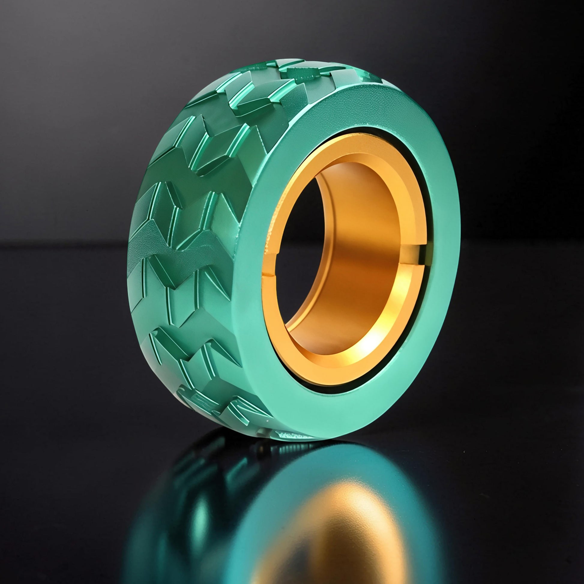 The Curious Mind Tire Haptic Ratchet Ring in teal metal with gold inner ring, tire tread design for tactile feedback.