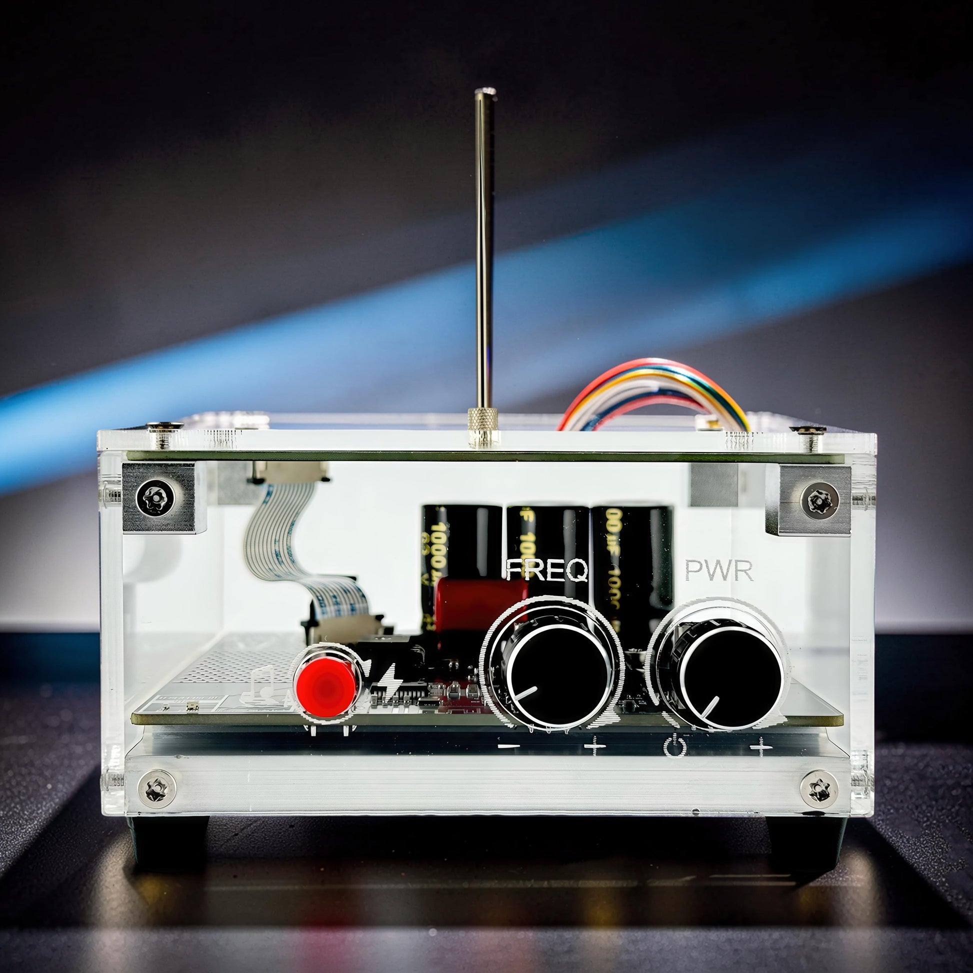 The Curious Mind Tesla Coil TC10 Plus pocket palm lightning plasma lamp with clear acrylic case, two knobs, red button, and internal components.