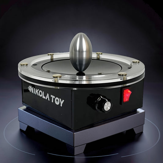 The Curious Mind Tesla Columbus Eggs Experiment Set, a metal egg balanced on a spinning black and silver device with a red switch.