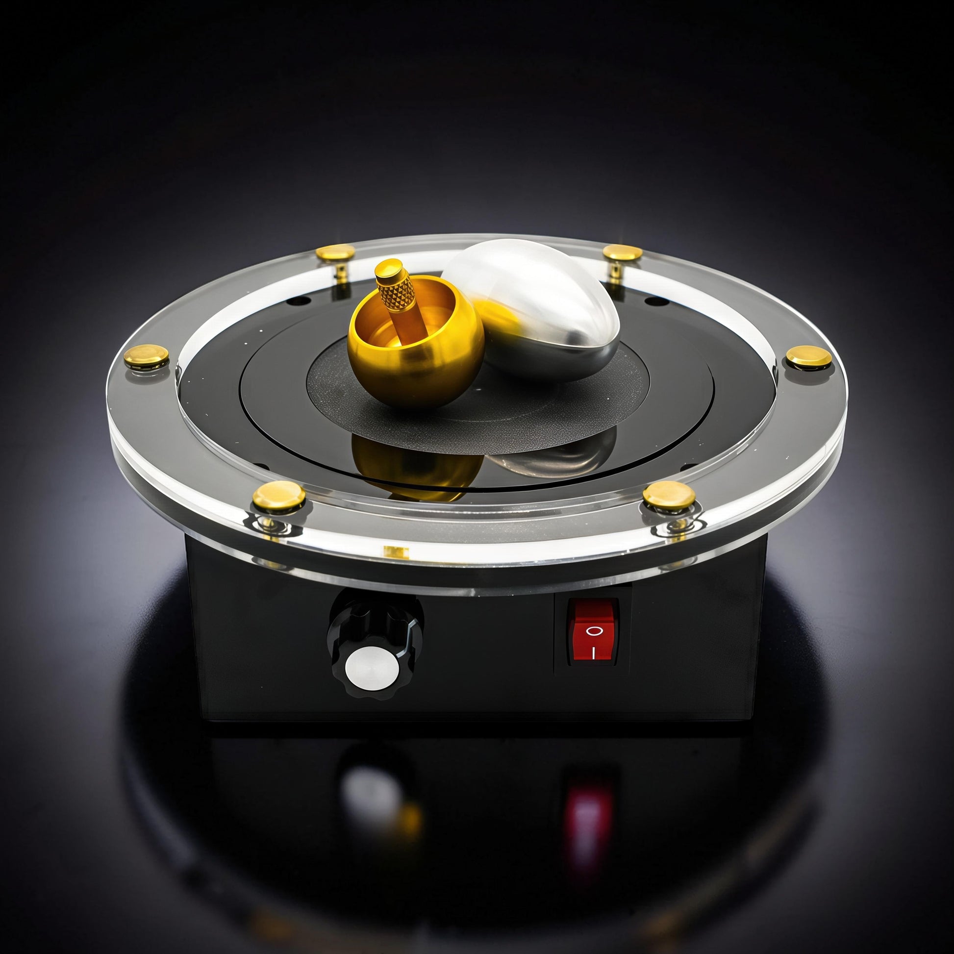 The Curious Mind Tesla Columbus Eggs Experiment Set features a gold spinning top and silver egg on a clear acrylic rotating platform with gold accents.