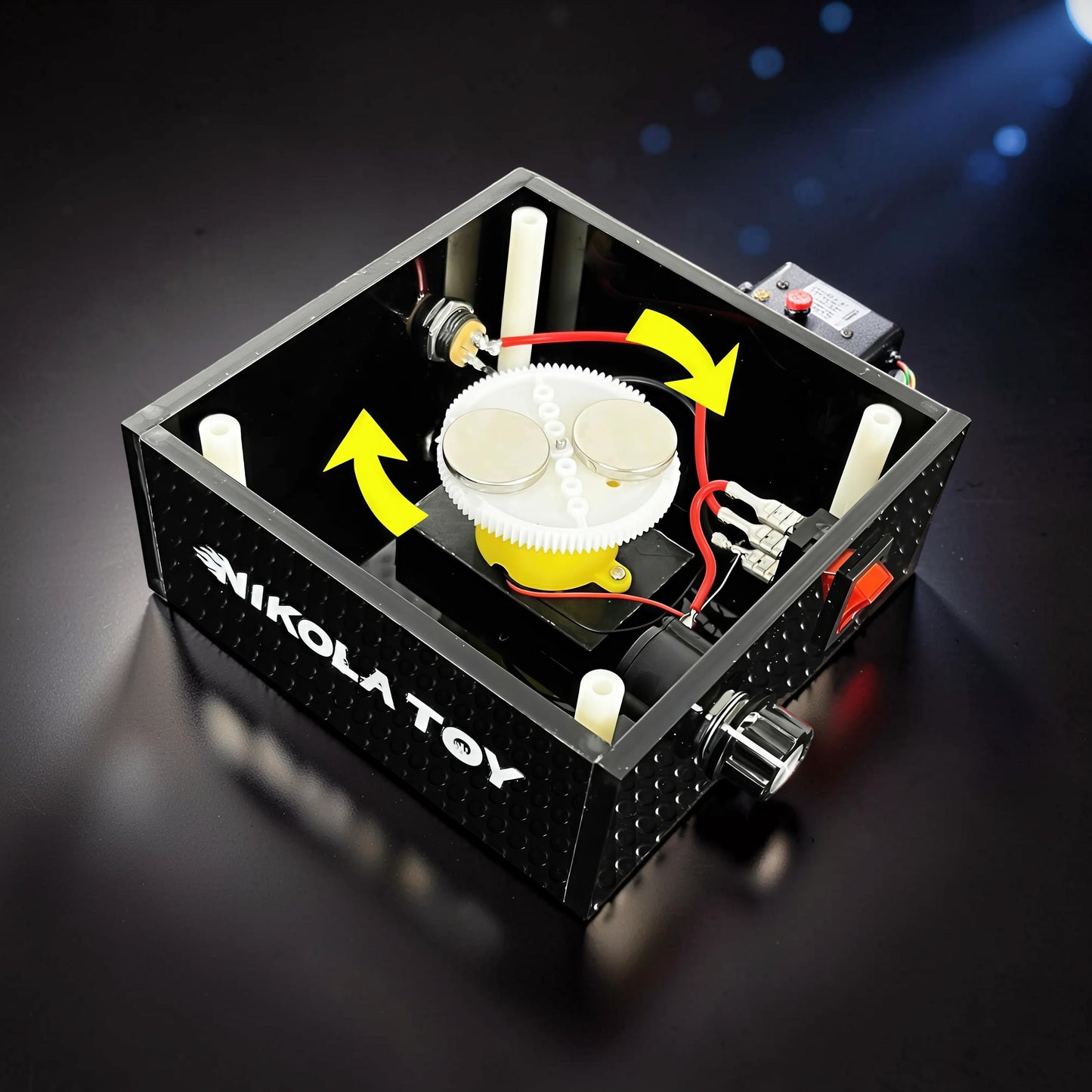 The Curious Mind Tesla Columbus Eggs Experiment Set, a metal and plastic interactive physics display with gears, magnets, and a switch.