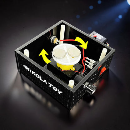 The Curious Mind Tesla Columbus Eggs Experiment Set, a metal and plastic interactive physics display with gears, magnets, and a switch.