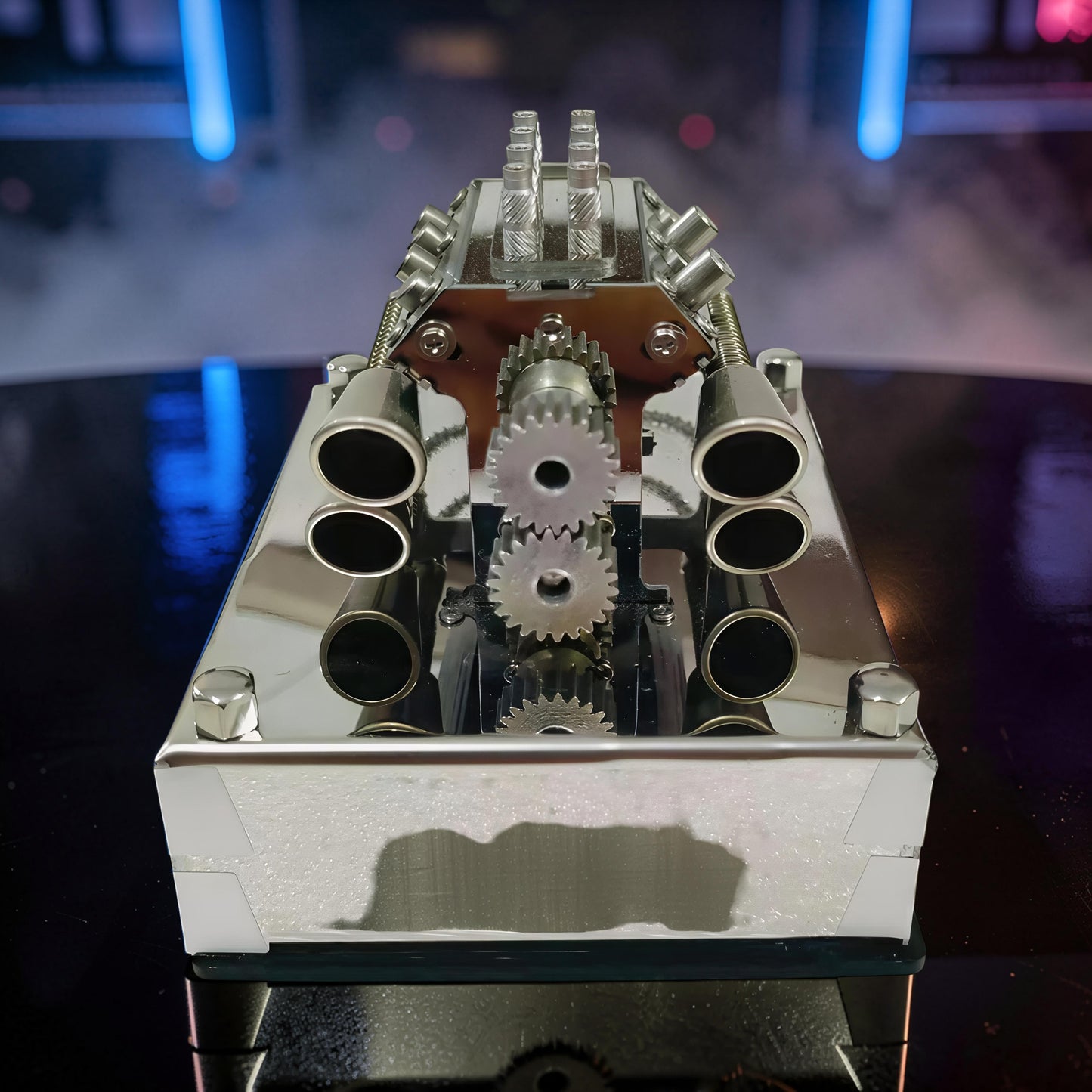 The Curious Mind V8 Beetle engine display model made of polished alloy metal and resin, featuring visible gears and exhaust pipes.