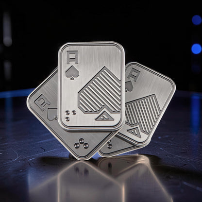 The Curious Mind Ace of Spades metal slider fidget toy, brushed silver with engraved spade design. Compact and tactile.