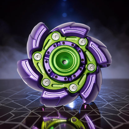 The Curious Mind Open Armour Hand Spinner, a metallic fidget toy in purple and green with a detailed, segmented design and central bearing.