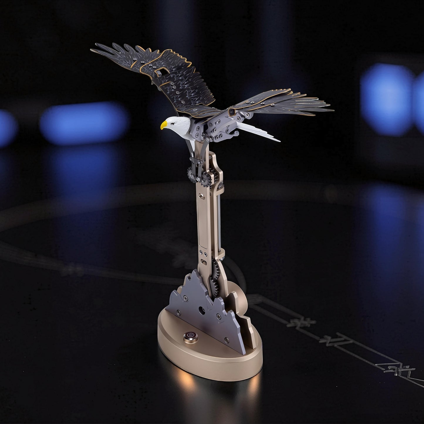 The Curious Mind Bald Eagle Flapping Wings DIY Kit, a metal mechanical model with intricate gears and detailed wings, perched on a gold base.