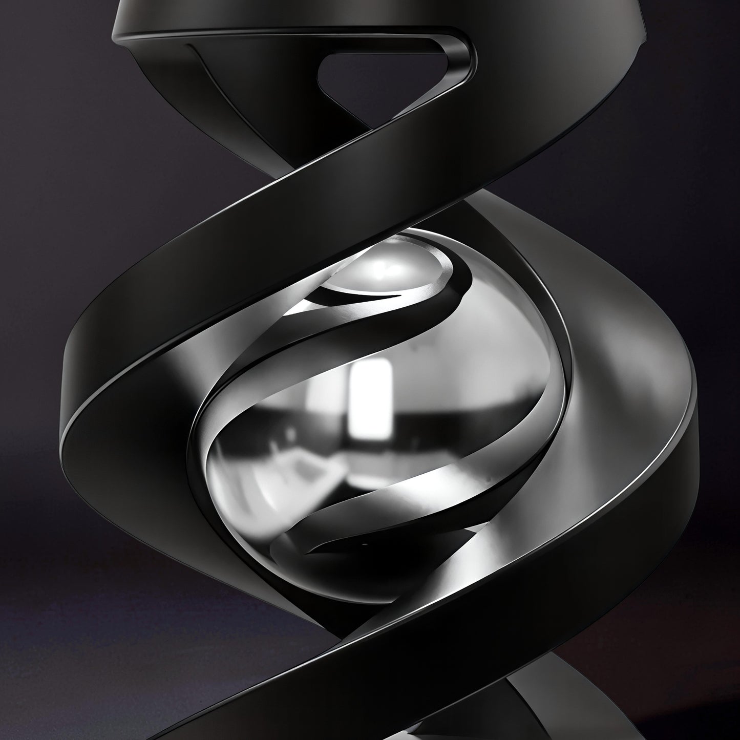 The Curious Mind Hypnosis Rotary Desk Spinner, a black metal abstract sculpture with a polished silver sphere at its center.