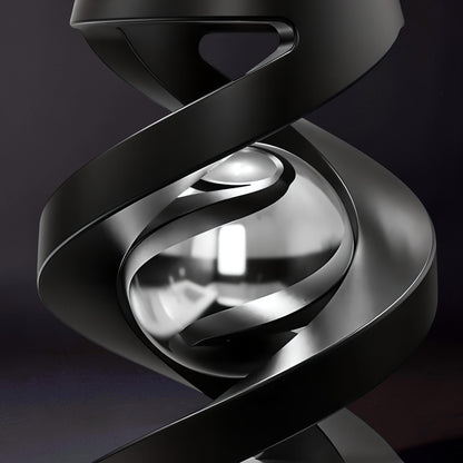 The Curious Mind Hypnosis Rotary Desk Spinner, a black metal abstract sculpture with a polished silver sphere at its center.