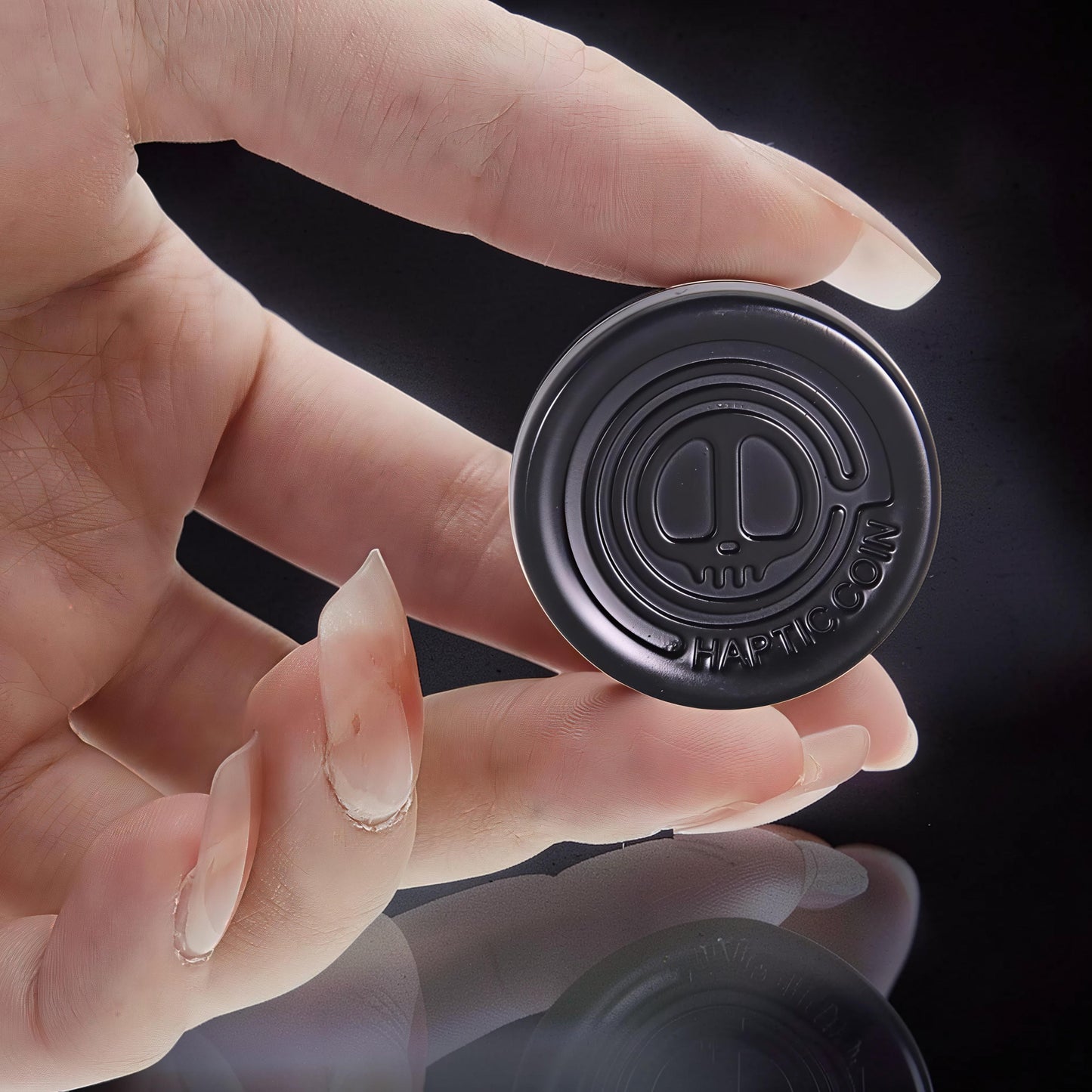 The Curious Mind Demon Coin Push Card Clicker, a compact black metal fidget toy with a demon skull design and satisfying click.
