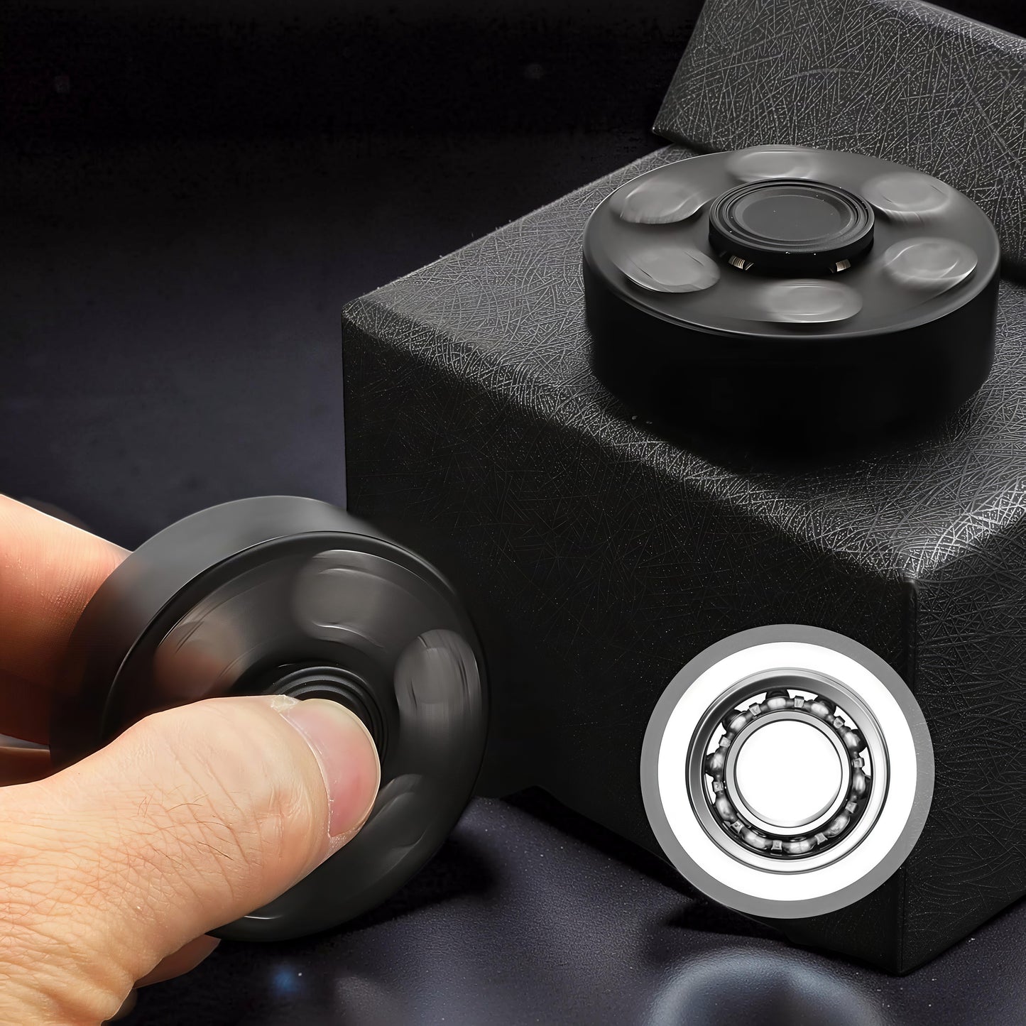 The Curious Mind black metal finger gyro spinner with six outer weights and a central bearing, shown in use and on display.