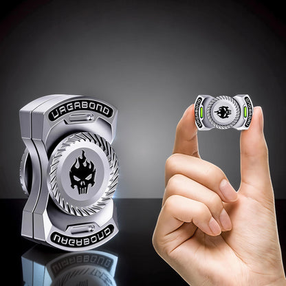 The Curious Mind Butterfly Plus Metal Spinner in black with a skull and flames design, held between fingers.