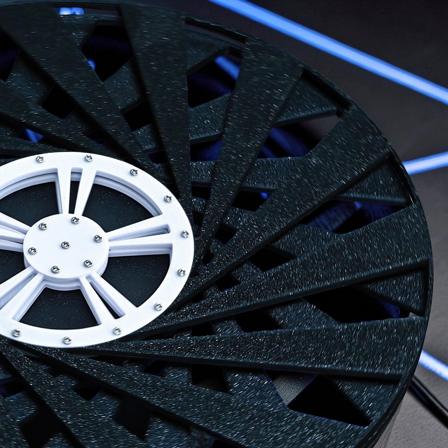 The Curious Mind Time Travel Edition desktop ornament, a black PLA kinetic sculpture with a white central wheel and silver screws.