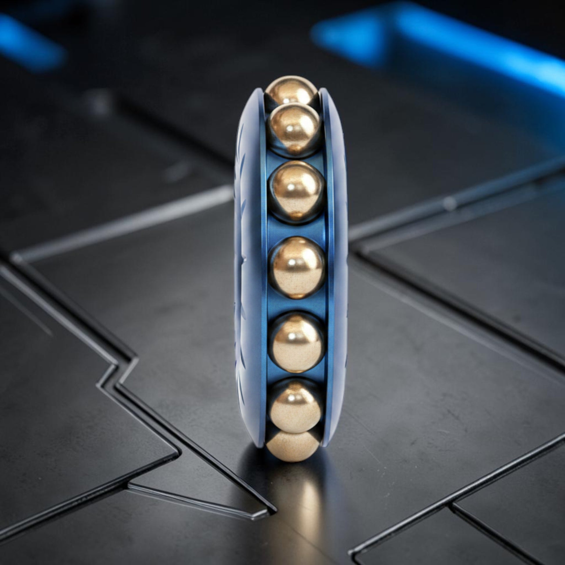 The Curious Mind blue metal bead wheel spinner with gold rolling beads for stress relief and focus.