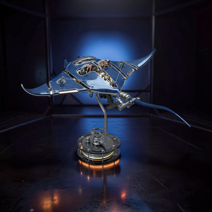 The Curious Mind blue metal manta ray mechanical ocean creature DIY kit with visible gears and a display stand.
